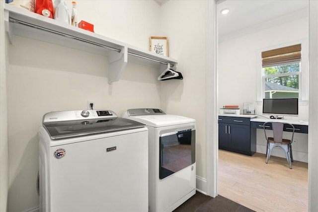 laundry room featuring hardwood / wood-style floors and washer and clothes dryer