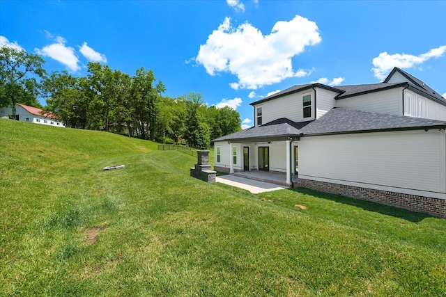 back of property with a lawn, ceiling fan, and a patio area