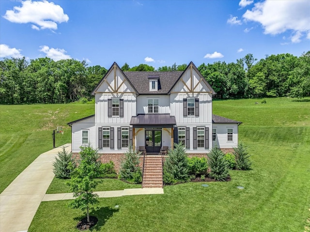 tudor house featuring a porch and a front yard