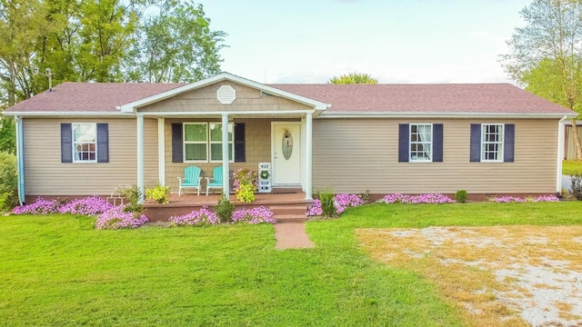 single story home featuring a front lawn and covered porch