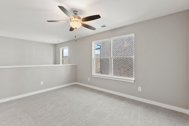 carpeted spare room with ceiling fan