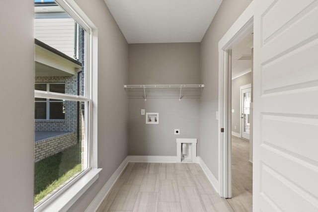 clothes washing area featuring electric dryer hookup, plenty of natural light, and washer hookup