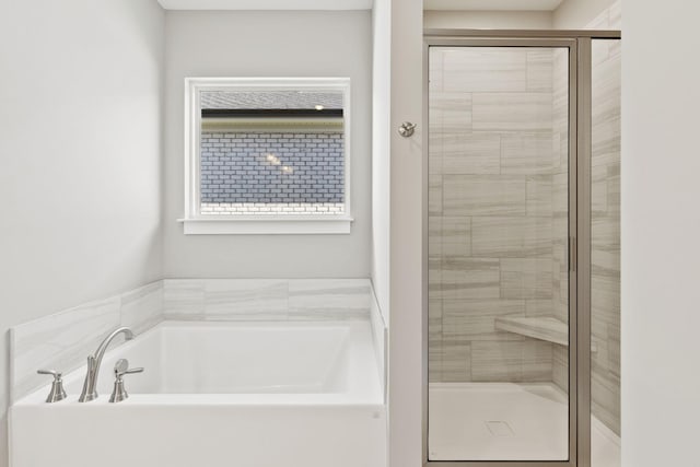 bathroom with separate shower and tub