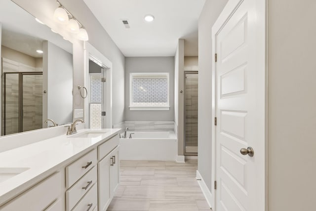 bathroom with independent shower and bath and vanity