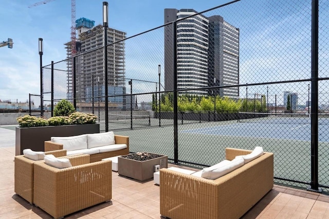 view of tennis court featuring an outdoor living space