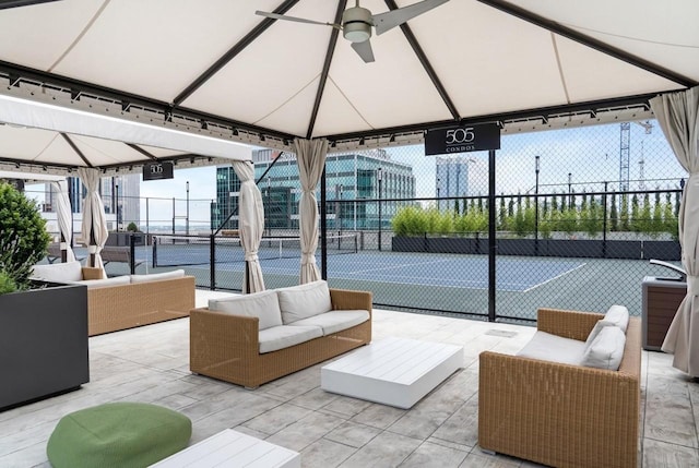 interior space with tennis court, outdoor lounge area, and a gazebo