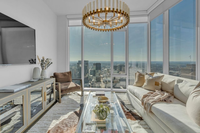 living room featuring a wall of windows, a healthy amount of sunlight, and a chandelier