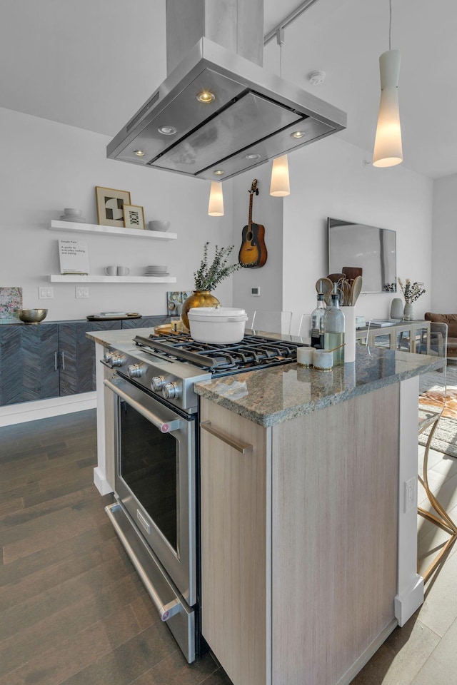 kitchen with hanging light fixtures, light brown cabinetry, dark stone counters, island exhaust hood, and high end range