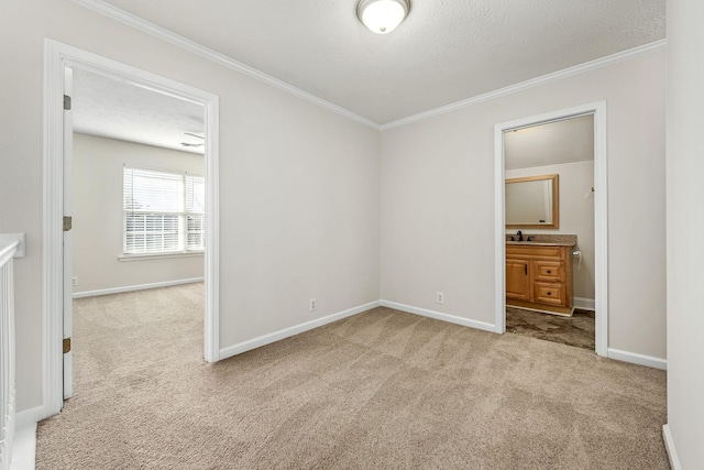 unfurnished bedroom featuring ornamental molding, ensuite bathroom, light carpet, and a textured ceiling