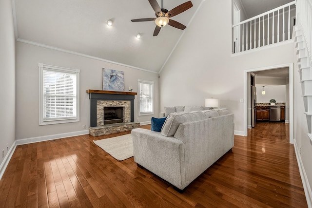 living room with dark hardwood / wood-style flooring, ornamental molding, plenty of natural light, and high vaulted ceiling