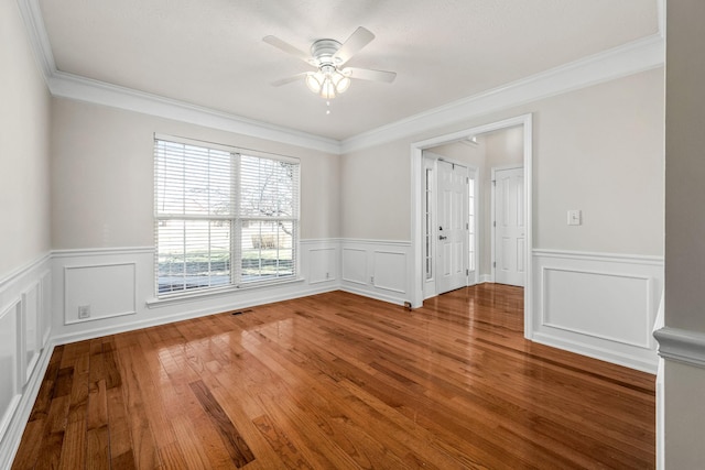 unfurnished room with hardwood / wood-style floors, crown molding, and ceiling fan