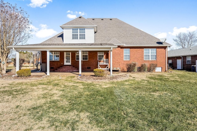 rear view of house featuring a lawn