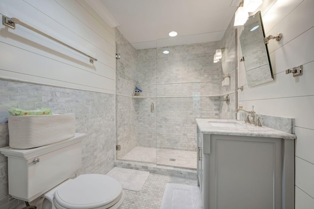 bathroom featuring tile patterned flooring, vanity, toilet, and a shower with door