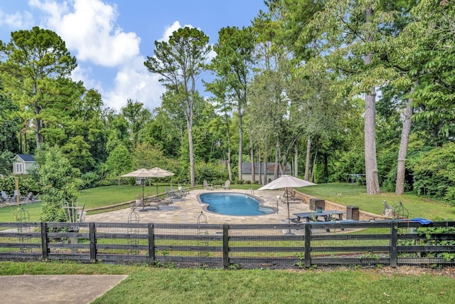 view of swimming pool with a yard and a patio