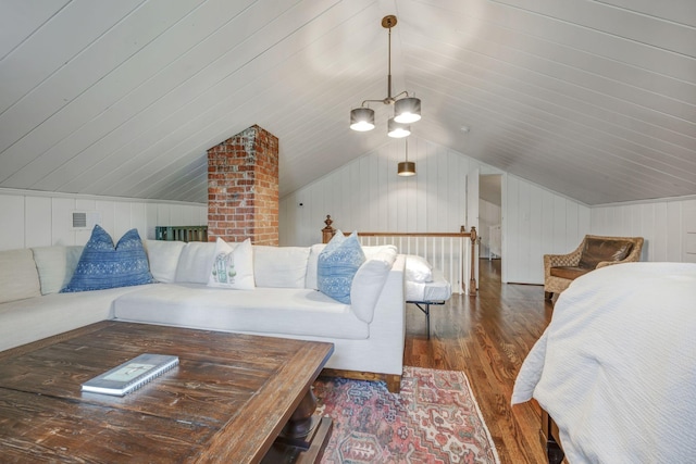 bedroom with lofted ceiling, a notable chandelier, dark wood-type flooring, and wood walls