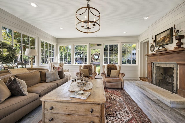 sunroom / solarium featuring an inviting chandelier