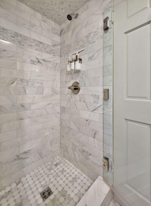 bathroom with a tile shower