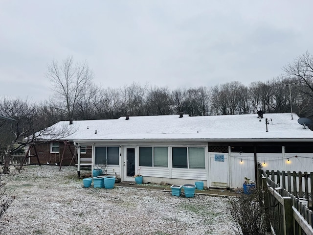 view of snow covered rear of property