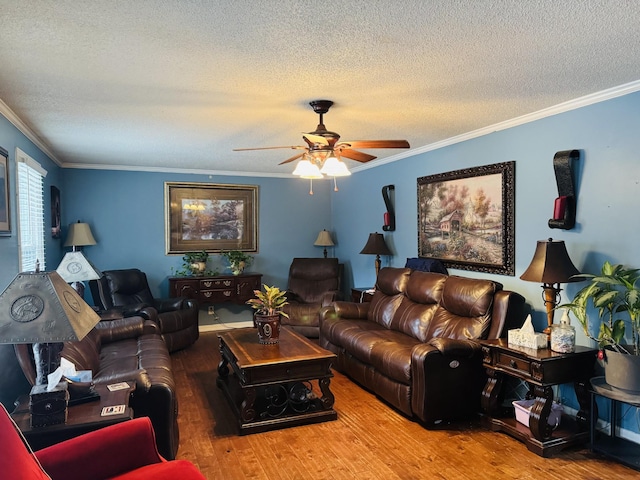 living room with a textured ceiling, light hardwood / wood-style floors, ceiling fan, and crown molding