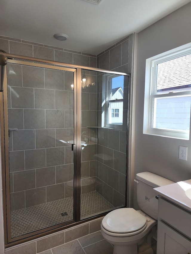 bathroom with vanity, toilet, an enclosed shower, and tile patterned flooring