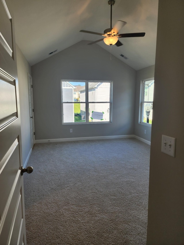 carpeted spare room with vaulted ceiling and ceiling fan