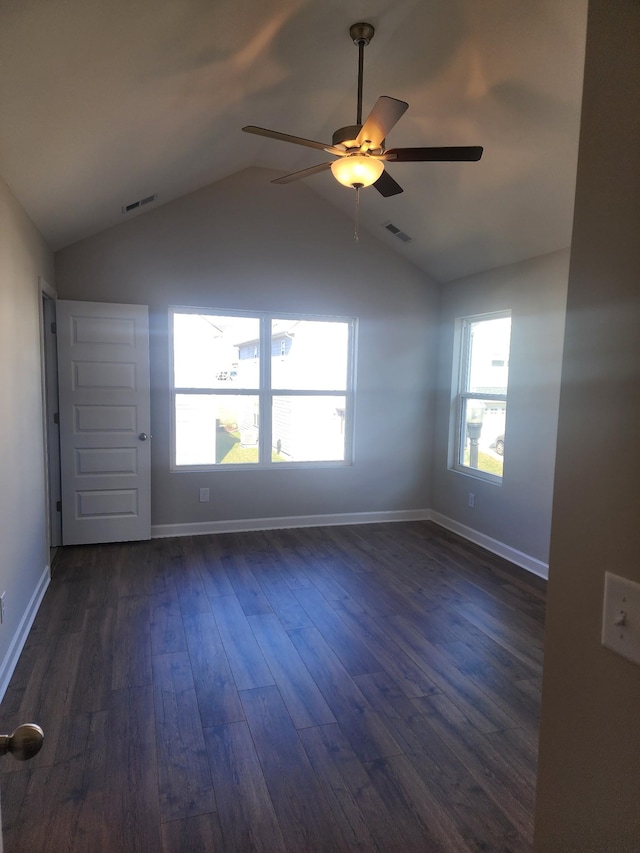 spare room featuring dark hardwood / wood-style flooring, lofted ceiling, and ceiling fan