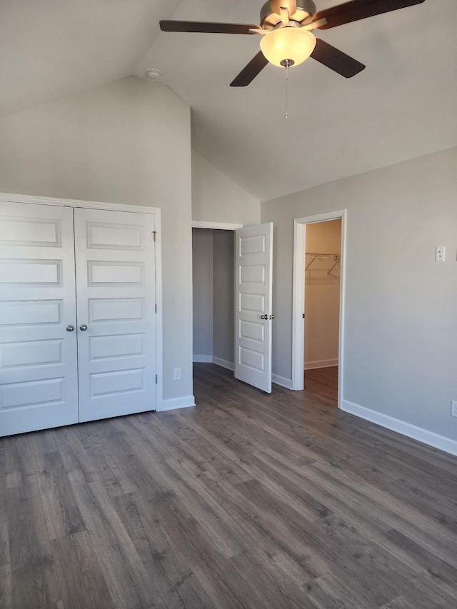 unfurnished bedroom with ceiling fan, lofted ceiling, dark hardwood / wood-style flooring, and a closet