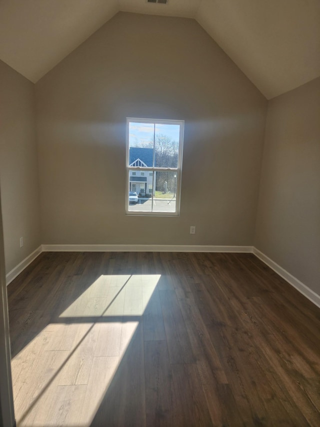 bonus room featuring dark hardwood / wood-style flooring and vaulted ceiling