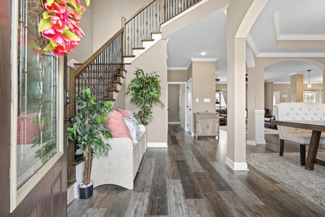 entrance foyer featuring crown molding and dark wood-type flooring