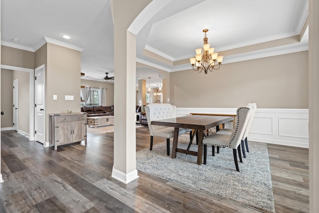 dining room featuring ceiling fan with notable chandelier, dark hardwood / wood-style flooring, and crown molding