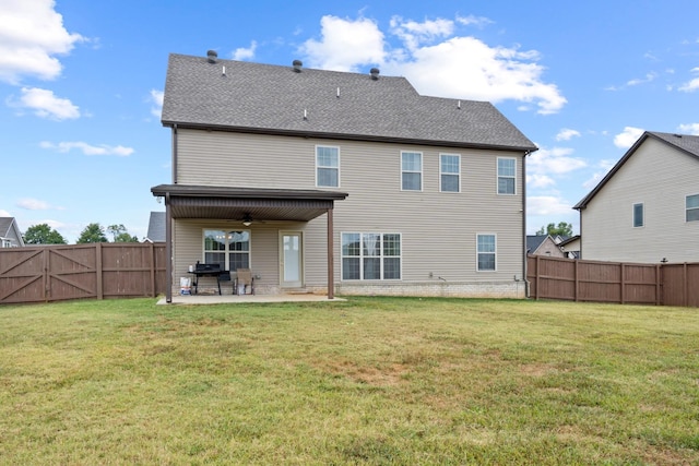 back of property with a patio, ceiling fan, and a lawn