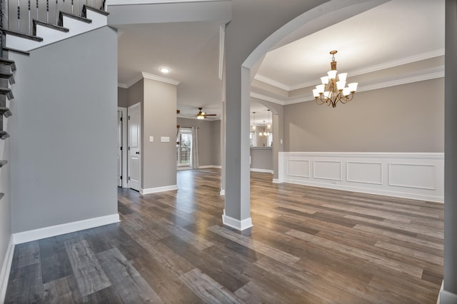 foyer entrance featuring dark hardwood / wood-style floors, ceiling fan with notable chandelier, and ornamental molding