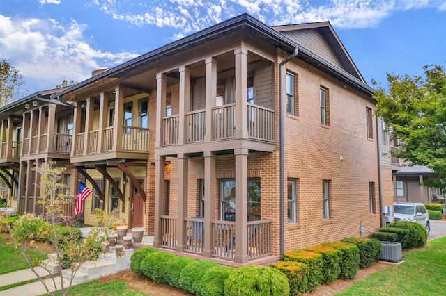 back of property with a balcony and cooling unit