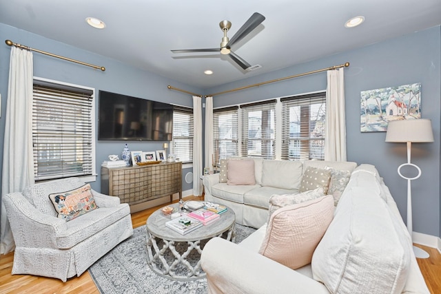 living room with light wood-type flooring and ceiling fan