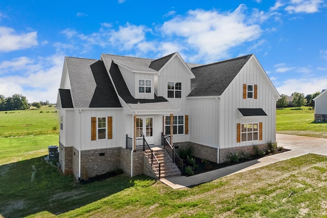 view of front of house with cooling unit and a front lawn