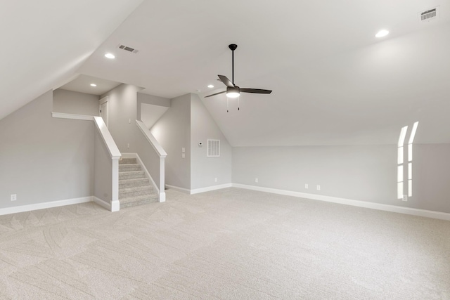 additional living space featuring ceiling fan, light colored carpet, and vaulted ceiling