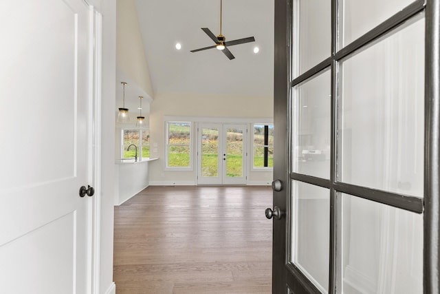 entrance foyer featuring ceiling fan, french doors, sink, high vaulted ceiling, and hardwood / wood-style flooring