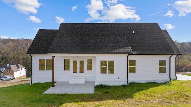 back of house with a lawn, a patio area, and french doors