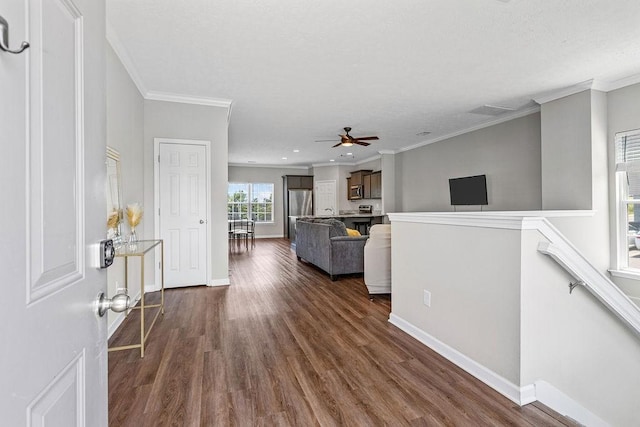 unfurnished living room featuring dark hardwood / wood-style flooring and crown molding