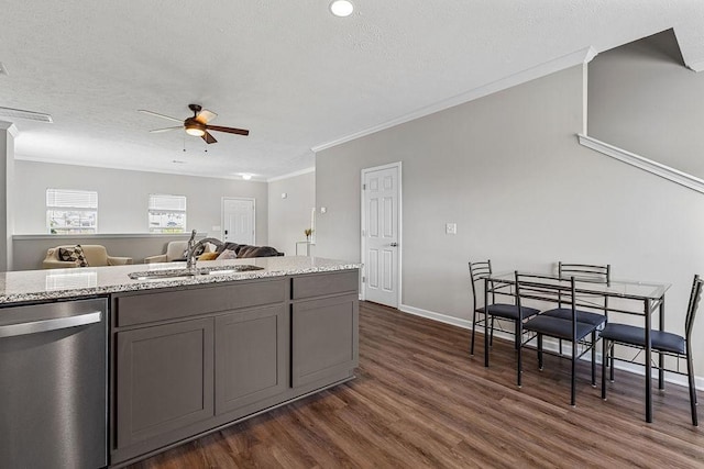 kitchen featuring dark hardwood / wood-style flooring, stainless steel dishwasher, ornamental molding, ceiling fan, and sink