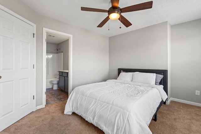 bedroom featuring ensuite bath, ceiling fan, and light carpet