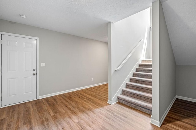 entryway featuring light hardwood / wood-style flooring and a textured ceiling