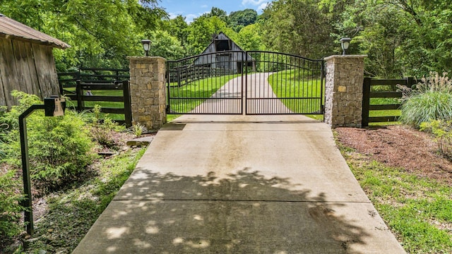 view of gate with a yard