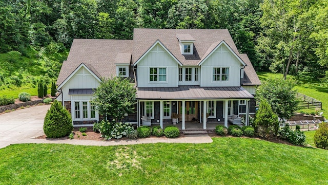 view of front of home with covered porch and a front yard