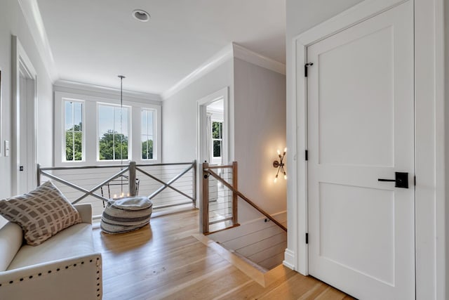 sitting room with light hardwood / wood-style flooring and ornamental molding