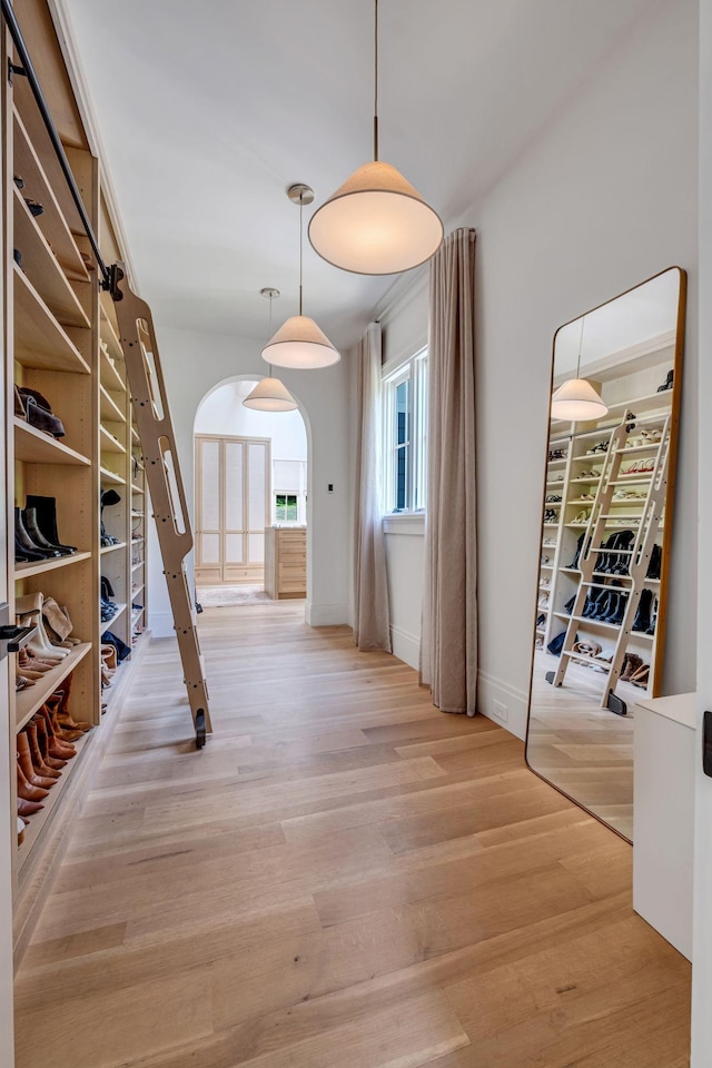 hallway with light hardwood / wood-style floors