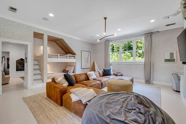 living room featuring an inviting chandelier and crown molding