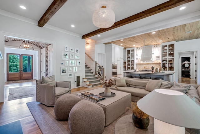 living room with french doors, an inviting chandelier, wooden ceiling, and light wood-type flooring