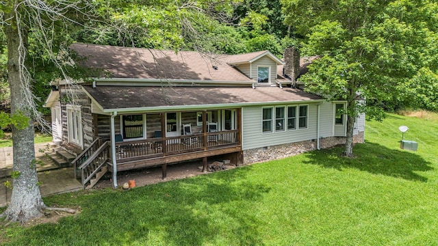 rear view of property featuring a lawn