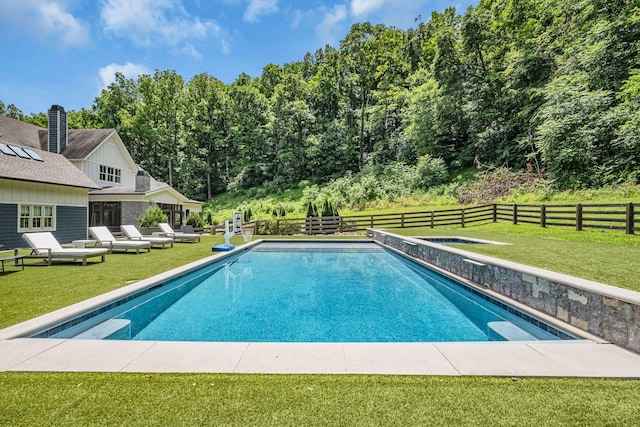 view of pool featuring a lawn